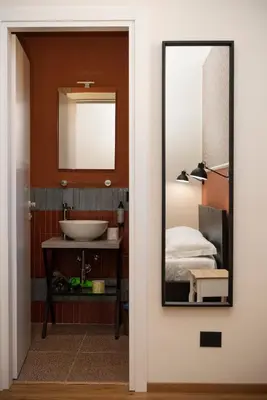 a bathroom with a mirror and a sink at By Lina in Trastevere in Rome