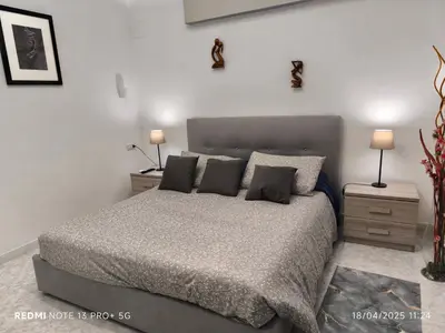 a bedroom with a large bed and two night stands at Maison Vittoria in Rome