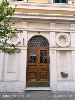 a building with a large wooden door on it at Maison Vittoria in Rome