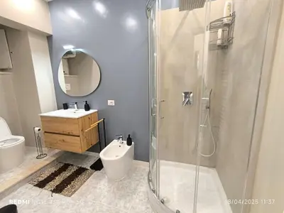 a bathroom with a shower and a toilet and a sink at Maison Vittoria in Rome