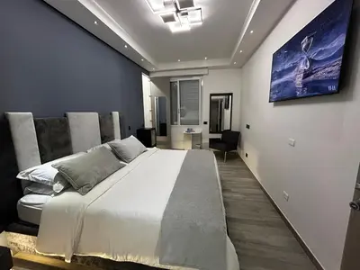 a bedroom with a large white bed and a couch at B&B GarbaCity-Inn in Rome