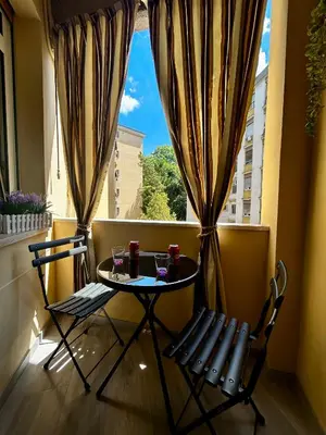 a table and chairs on a balcony with a view at B&B GarbaCity-Inn in Rome