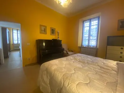 a bedroom with a large bed and a piano at Villetta Garbata in Rome
