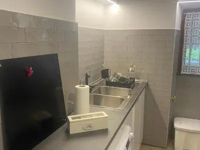 a small bathroom with a sink and a toilet at Villetta Garbata in Rome
