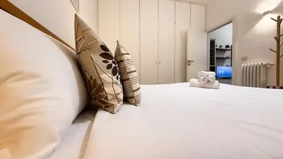 a bedroom with a bed with pillows on it at Elegant Stay a Stone's Throw from Libya Metro in Rome