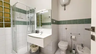 a bathroom with a sink and a toilet and a shower at Elegant Stay a Stone's Throw from Libya Metro in Rome