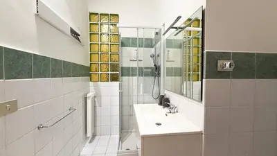 a bathroom with a sink and a shower at Elegant Stay a Stone's Throw from Libya Metro in Rome