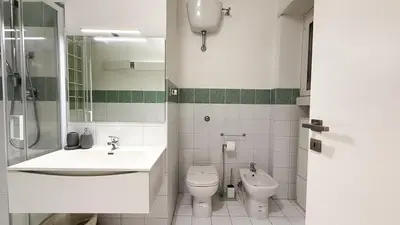 a bathroom with a sink and a toilet and a shower at Elegant Stay a Stone's Throw from Libya Metro in Rome