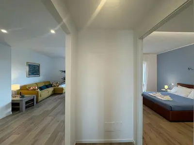 a bedroom and living room with a bed and a couch at Sunny Stay with a Roman Soul in Rome