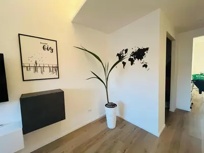 a plant in a vase in a living room at Sunny Stay with a Roman Soul in Rome