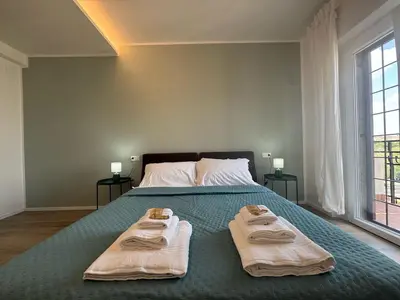 a bedroom with a bed with two towels on it at Sunny Stay with a Roman Soul in Rome