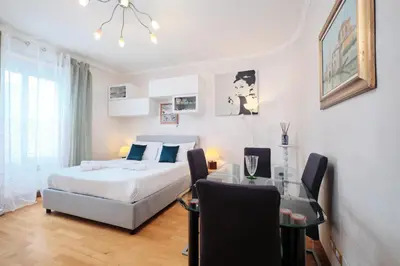 a bedroom with a bed and a table and a bed and a dining room at Metro A 10 minutes - Free Wi-Fi & Netflix in Rome