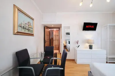 a living room with chairs and a dining room at Metro A 10 minutes - Free Wi-Fi & Netflix in Rome