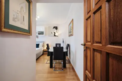 a dining room with a table and black chairs at Metro A 10 minutes - Free Wi-Fi & Netflix in Rome
