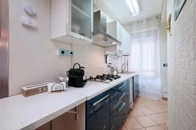 a kitchen with a stove and a counter top at Metro A 10 minutes - Free Wi-Fi & Netflix in Rome
