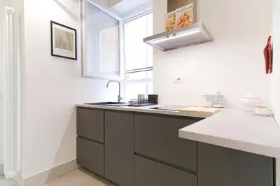 a kitchen with a sink and a window at Elegantis Trastevere Modern Apartment - Comfort in Rome Most Charming District in Rome