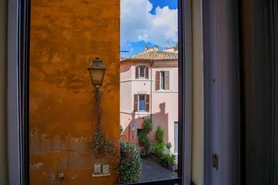 a view from a window of a building with a street at Elegantis Trastevere Modern Apartment - Comfort in Rome Most Charming District in Rome