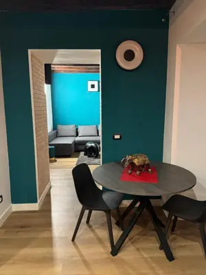 a table and chairs in a room with green walls at Elephant Parliament Apt in Rome