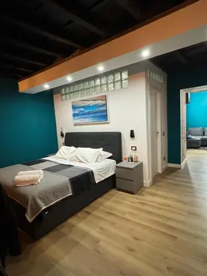 a bedroom with a large bed and a blue wall at Elephant Parliament Apt in Rome
