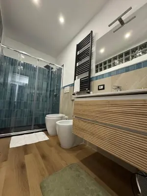 a bathroom with two toilets and a glass shower at Elephant Parliament Apt in Rome