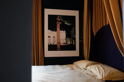 a bedroom with a picture on the wall and a bed at Testaccio Room in Rome in Rome