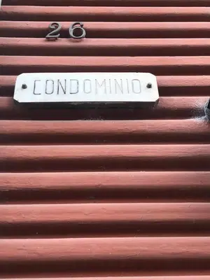 a sign on the side of a wooden wall at Testaccio Room in Rome in Rome