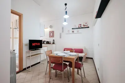 a kitchen and dining room with a table and chairs at Tuscolana Station - 10 minutes from Metro A in Rome