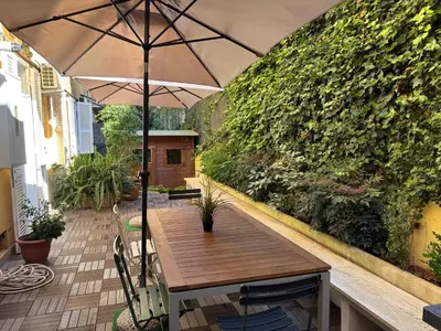 a wooden table with an umbrella on a patio at da Nonna Dina in Rome