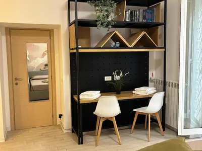 a room with a desk and two white chairs at da Nonna Dina in Rome