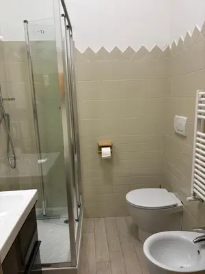 a bathroom with a shower and a toilet and a sink at da Nonna Dina in Rome