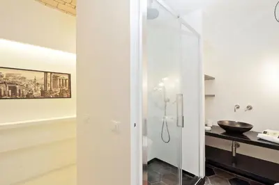 a bathroom with a glass shower with a sink at YCH-Laterano Charme in Rome