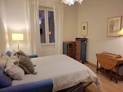 a bedroom with a bed with a teddy bear on it at Appartamento viale Mazzini in Rome