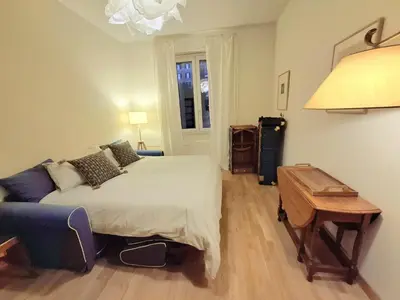 a bedroom with a bed and a couch and a table at Appartamento viale Mazzini in Rome