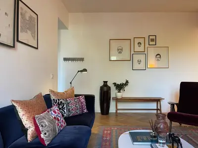 a living room with a blue couch and a table at Terme di Tito Colosseum in Rome