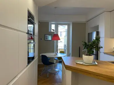 a kitchen and living room with a table and a dining room at Terme di Tito Colosseum in Rome