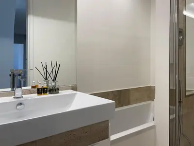a bathroom with a white sink and a shower at Terme di Tito Colosseum in Rome