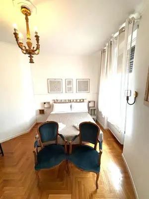 a bedroom with a bed and a table and chairs at Vatican Home - San Pietro - Near to Metro A in Rome