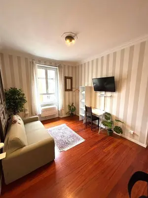 a living room with a couch and a desk at Vatican Home - San Pietro - Near to Metro A in Rome
