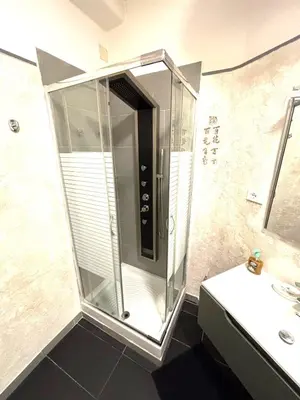 a glass shower in a bathroom with a sink at Vatican Home - San Pietro - Near to Metro A in Rome