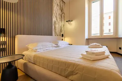 a bedroom with a large bed with towels on it at Minerva Boutique Suites in Rome