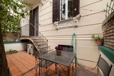 a table and chairs on a patio with a staircase at GuestHost - Roma Termini Lovely Flat in Rome