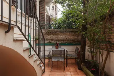a patio with a table and chairs in a building at GuestHost - Roma Termini Lovely Flat in Rome