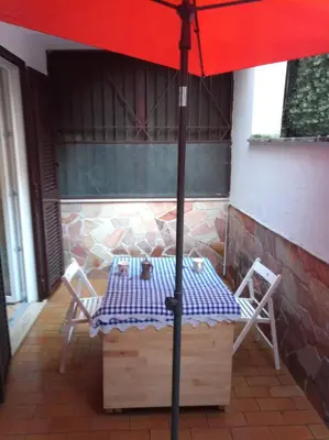 a table and chairs under an umbrella on a patio at My Cocoon in Rome