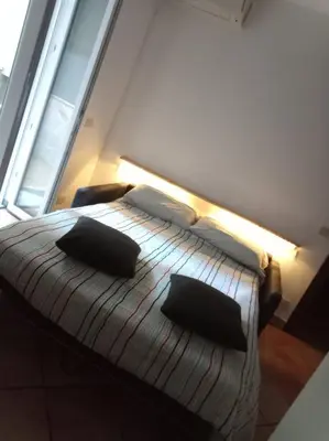 a bedroom with a bed with two pillows on it at My Cocoon in Rome