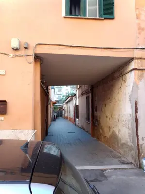 an alley with a car parked next to a building at My Cocoon in Rome
