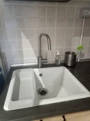 a white sink with a faucet in a kitchen at My Cocoon in Rome