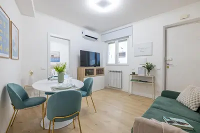 a living room with a table and chairs and a couch at NOSTROMONDO-Elegant Suite with patio in Monti Parioli in Rome