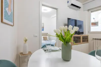 a vase of flowers sitting on a table in a living room at NOSTROMONDO-Elegant Suite with patio in Monti Parioli in Rome