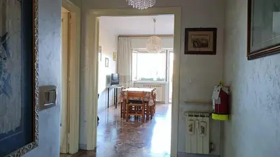 a hallway with a table and a dining room at A casa di Ugo - Colors and space at Pigneto, Rome in Rome
