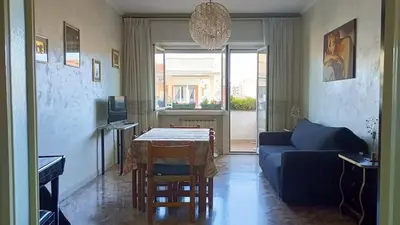 a living room with a blue couch and a table at A casa di Ugo - Colors and space at Pigneto, Rome in Rome